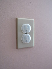 An American outlet with safety childproof outlet covers on them 