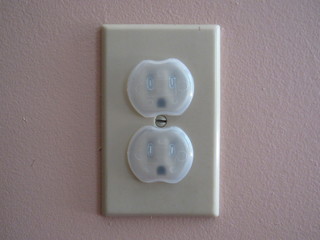 An American outlet with safety childproof outlet covers on them 