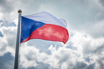 Czech Republicflag in the sky/ national flag of the Czech Republic in the wind on a flagpole against a background of clouds in the sky
