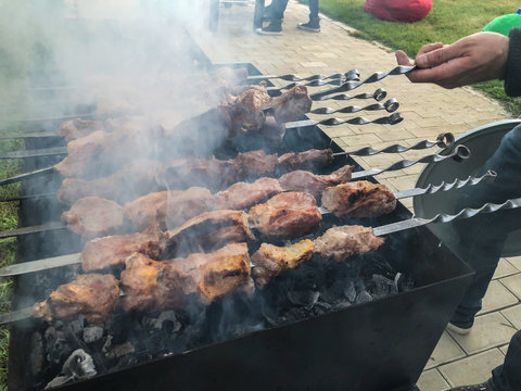 Mcvadi - shashlik preparing on a barbecue grill over charcoal. Roasted stacked meat Shish kebab popular in Goergia. Traditional cuisine in Georgia