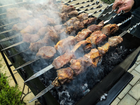 Mcvadi - shashlik preparing on a barbecue grill over charcoal. Roasted stacked meat Shish kebab popular in Goergia. Traditional cuisine in Georgia