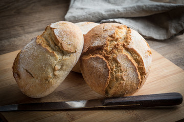 Roll breads on cutting board.