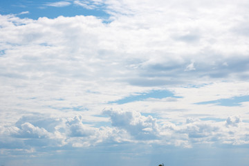 The blue sky, covered with white clouds on a warm summer day