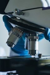 Scientist hands with microscope close-up shot in the laboratory