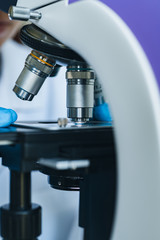 Scientist hands with microscope close-up shot in the laboratory