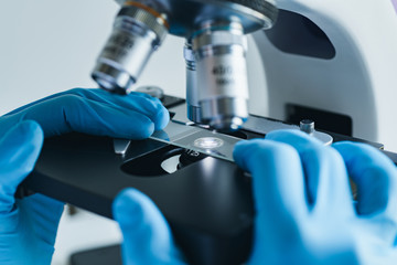 Scientist hands with microscope close-up shot in the laboratory