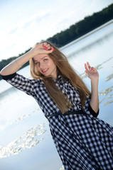 Petite woman wearing dress at lake