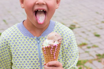 A little girl is eating ice cream.