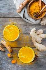 Traditional indian drink turmeric curcuma golden milk with ingredients