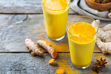 Traditional indian drink turmeric curcuma golden milk with ingredients