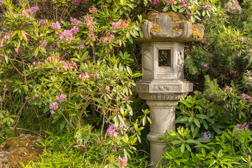 Fototapeta na wymiar Japanese Pagoda Lantern Within Green Garden Setting