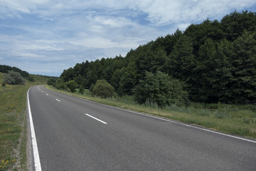 Fototapeta na wymiar Empty road for cars around green nature