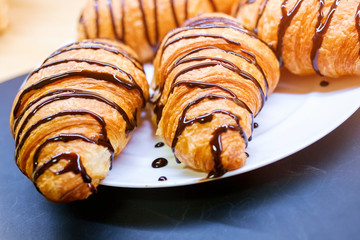Croissants with chocolate on plate. 