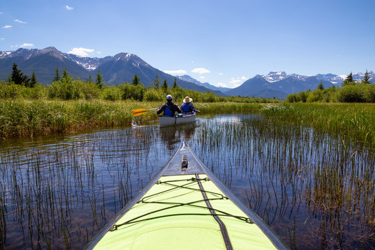 Kayaking in a lake surrounded by the Canadian mountains. Taken in Vermilion Lakes, Banff, Alberta, Canada.