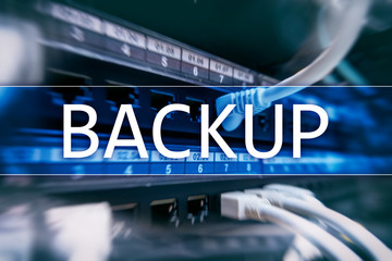Backup button on modern server room background. Data loss prevention. System recovery.