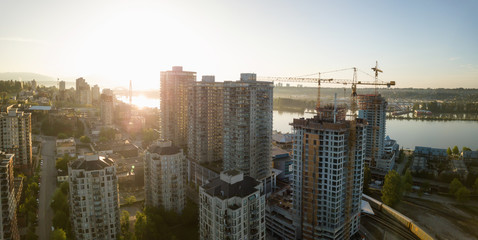 Obraz premium Aerial view of Residential Buildings in the city during a vibrant sunrise. Taken in New Westminster, Greater Vancouver, British Columbia, Canada.