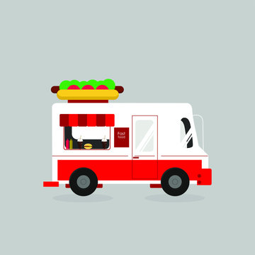 Fast Food Concept. White And Red Truck Decorated With Huge Hot Dog Selling Fast Food Isolated On Grey Background.