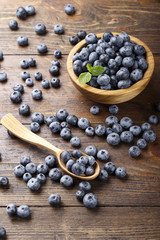 fresh blueberries in a wooden spoon