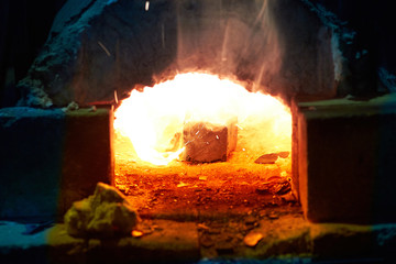 Fire in the furnace in the smithy, tools. Concept: blacksmithing, forge