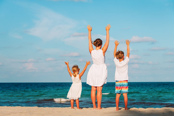 happy family - mother with son and daughter enjoy beach