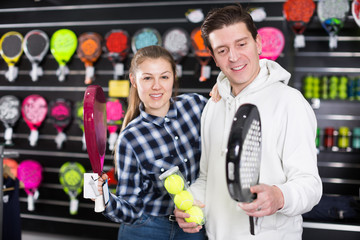 Female with male with racket and balls for padel
