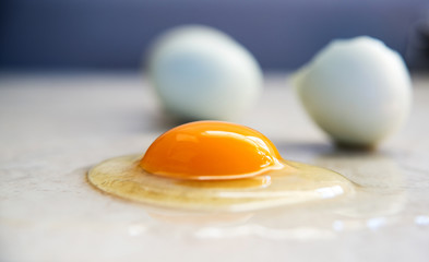 Organic Egg is Being Broken on Smooth Countertop