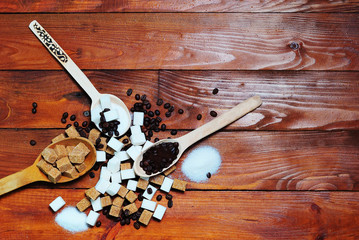 Grains of coffee and white and brown lump sugar