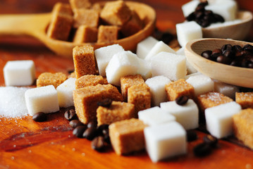 Grains of coffee and white and brown lump sugar