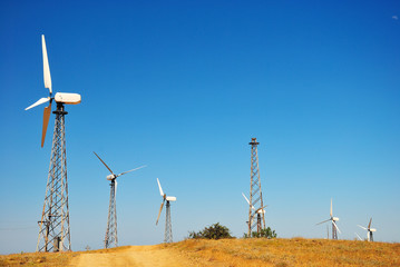 Wind power station against a clear blue sky