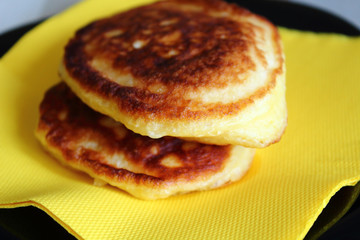Fresh tasty muffins on a plate. Pancakes are handmade. Close-up. Background.
