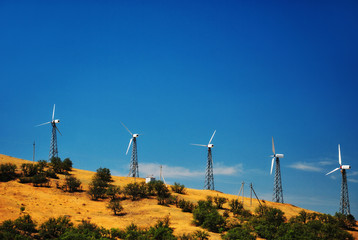 Wind power station against a clear blue sky