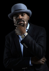 Image of handsome african man wearing hat posing in studio.