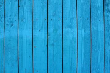 Boards painted in blue paint. Vertical view. Close-up. Background. Texture.