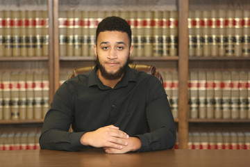 Portrait of a biracial multiethnic young man.  Portrait of a lawyer in law office.