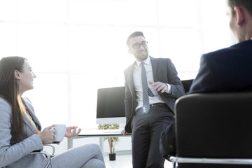 Smiling work team during break time in bright office