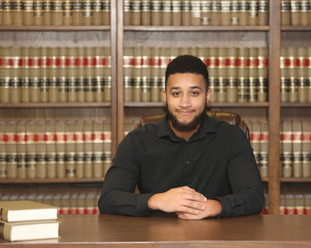 Portrait of a biracial multiethnic young man.  Portrait of a lawyer in law office.
