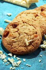 stack of macadamia nut and white chocolate cookies on table with chocolate chip