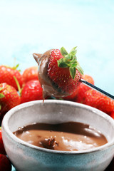 Fondue with Melting chocolate or melted chocolate and strawberry.