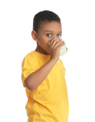 Adorable African-American boy with glass of milk on white background