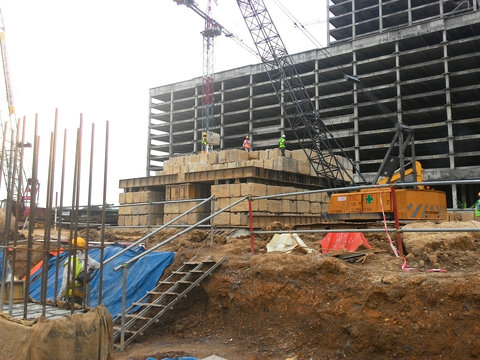 Construction workers stacking the maintain load test block at the construction site. The block used to test the piling integrity. 