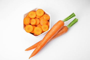 Ripe fresh carrots on white background