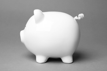 Cute white piggy bank on gray background