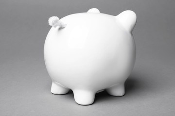 Cute white piggy bank on gray background