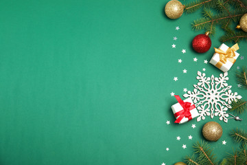 Flat lay composition with Christmas tree branches and festive decor on color background