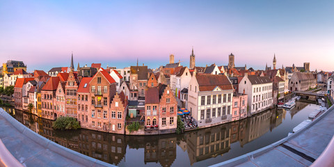 Panoramic aerial view of picturesque medieval buildings on the quay Graslei, Leie river and towers of Old Town at sunset, Ghent, Belgium
