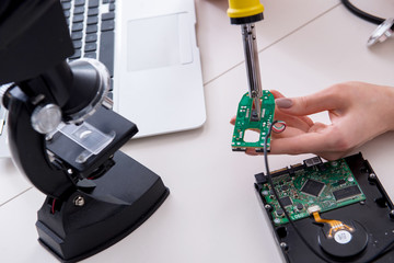 Engineer fixing broken computer hard drive