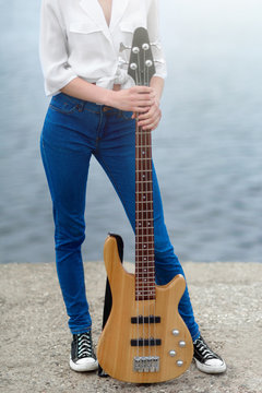 Girl holding a bass guitar