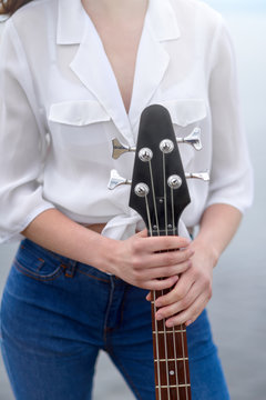 Girl holding a bass guitar