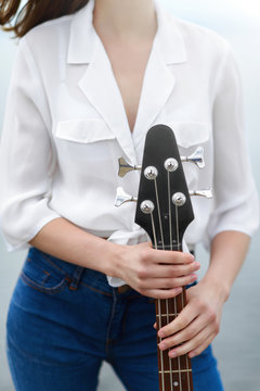 Girl holding a bass guitar