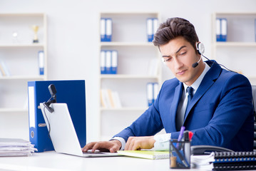 Young help desk operator working in office